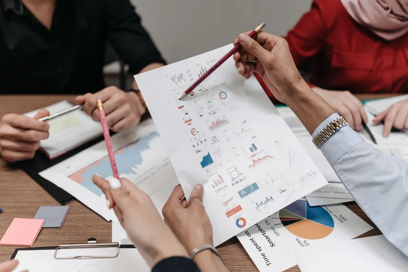 Team reviewing reports and charts during a working meeting